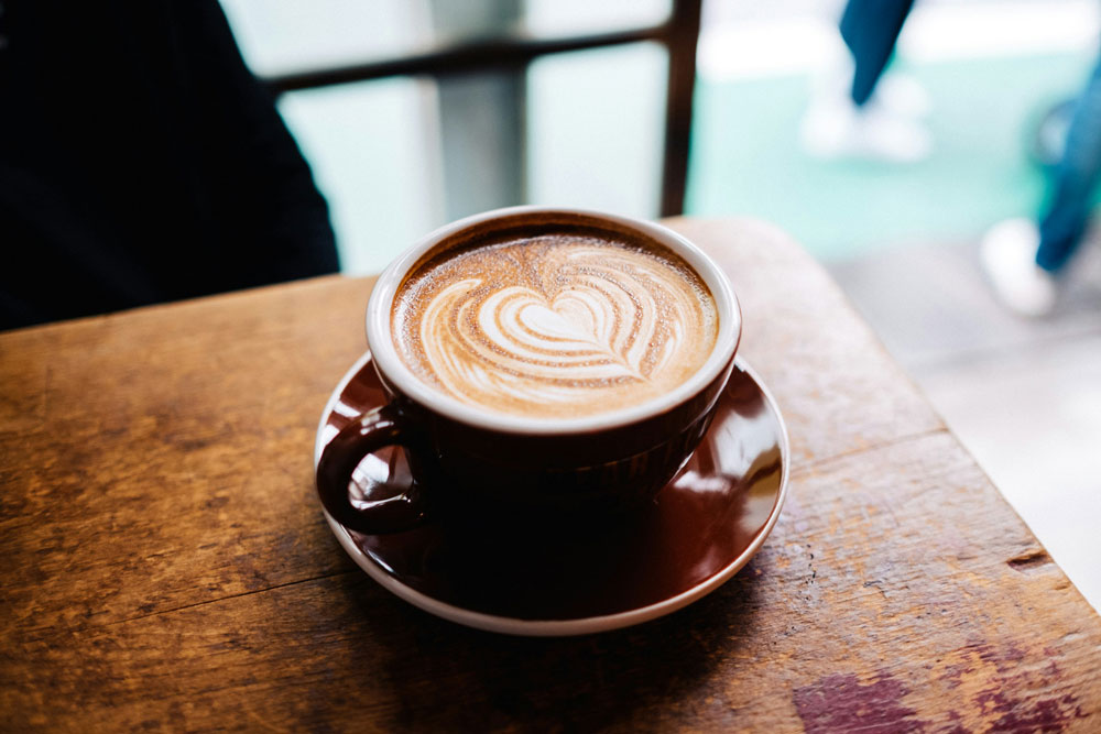 a cappuccino in a mug on a coffee table